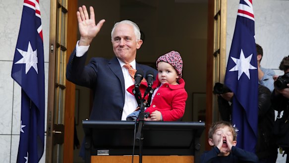 Malcolm Turnbull waves goodbye at the end of his final press conference as prime minister, surrounded by granddaughter Alice and grandson Jack. 