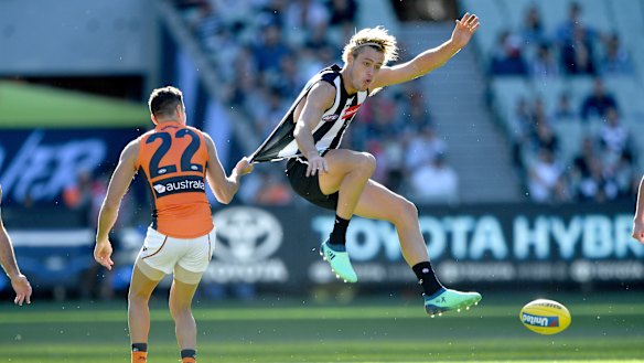 No holds barred: Giant Josh Kelly restrains Collingwood's Darcy Moore during their round two clash.