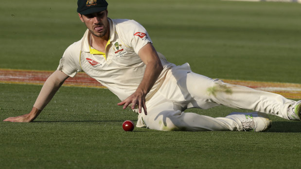 Australia's bowler Pat Cummins fields off the ball.