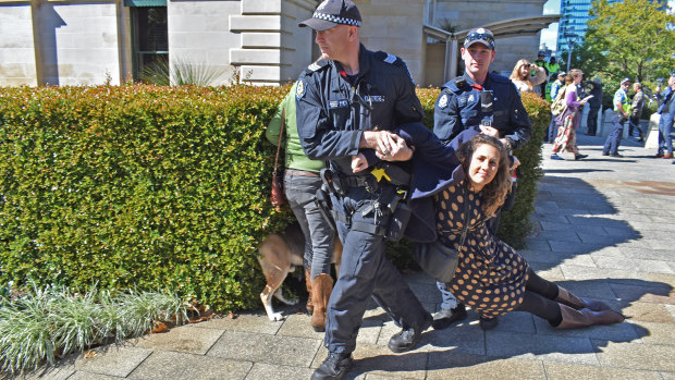 A protester is arrested by police at WA Parliament on Thursday, August 15, 2019.