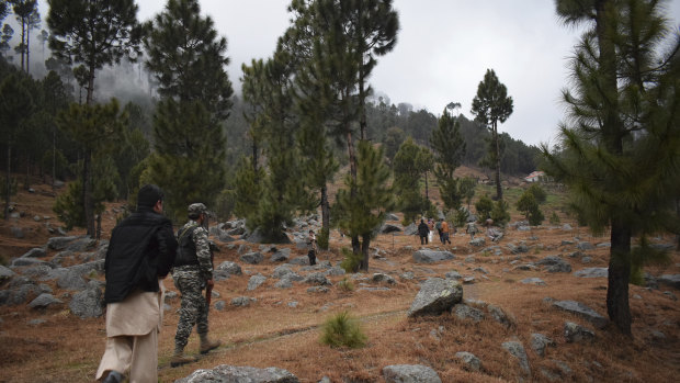 Pakistani troops visit the site of an Indian air strike in Jaba, near Balakot, Pakistan, on Tuesday. Pakistan said there were no casualties.