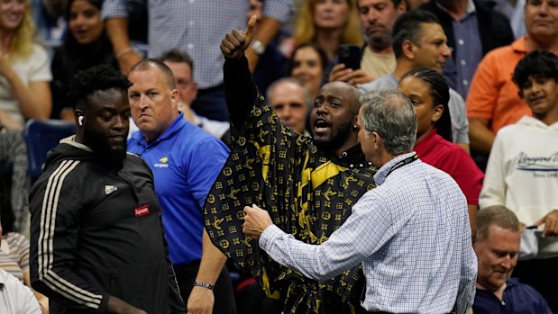 JiDion gets escorted out of Arthur Ashe Stadium. 