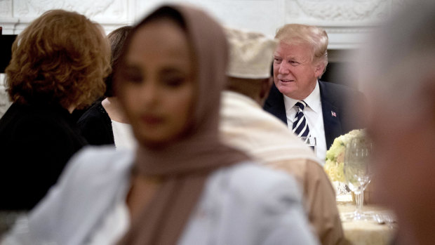 President Donald Trump sits down for an iftar dinner at the White House last year.