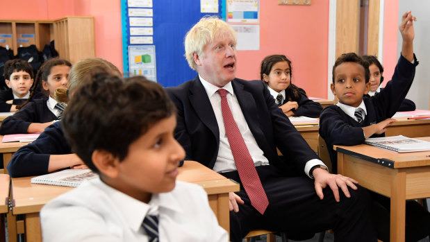 Britain's Prime Minister Boris Johnson attends a year six history class with pupils during a visit to Pimlico Primary School.