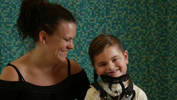 Kristie Duck and her son Kobe, 6, who has a rare disease that has left him paralysed. 