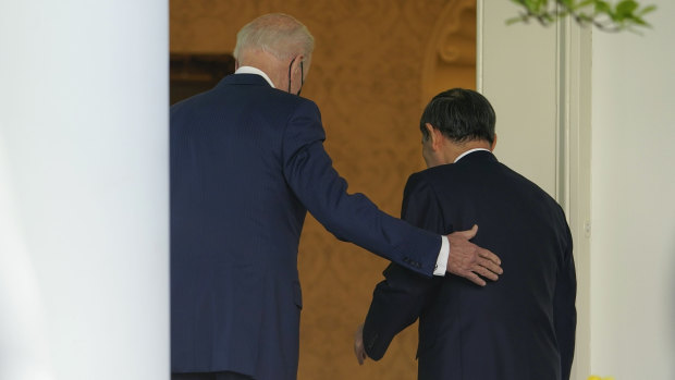 US President Joe Biden, accompanied by Japanese Prime Minister Yoshihide Suga, walk back into the Oval Office after a news conference in the Rose Garden of the White House in Washington.