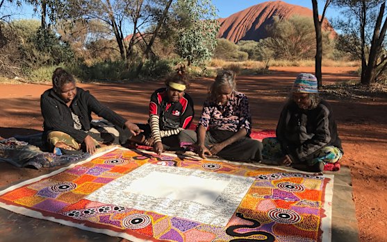 Artists complete their work on the Uluru Statement of the Heart in 2017. 