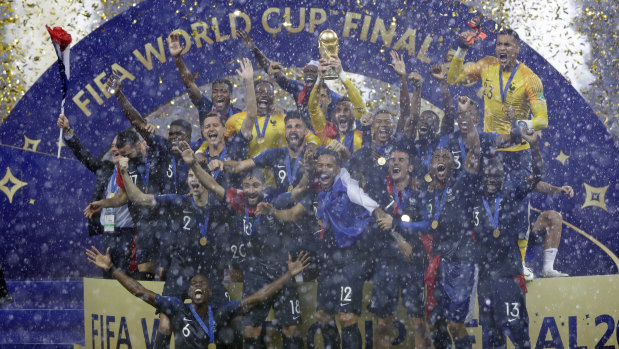 France goalkeeper Hugo Lloris holds the trophy aloft.