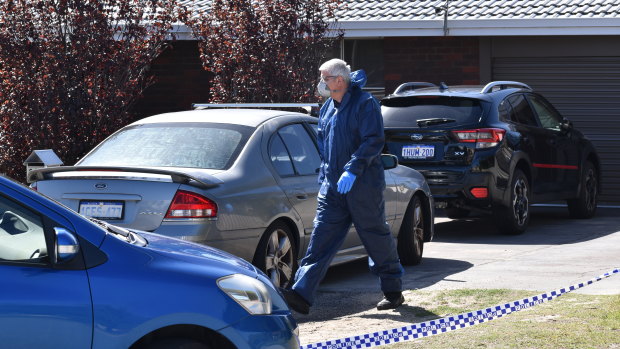 Homicide detectives and forensic officers were examining the scene where a woman died on Monday.