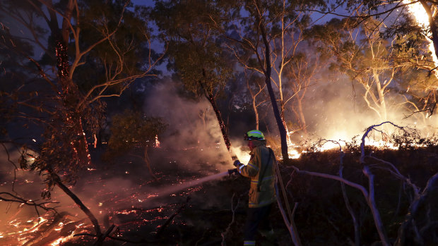 A firefighter tackles bushfires in NSW.
