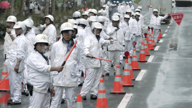 Police officers control traffic prior to the two-day world leaders' summit in Osaka.