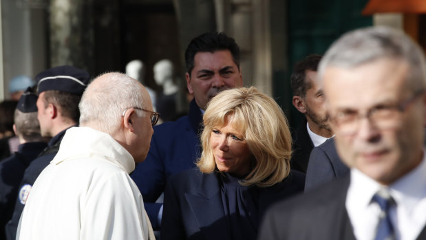 French First Lady Brigitte Macron, centre, arrives to attend a mass, as part of the Holy Week, at the Saint Sulpice Church in Paris.