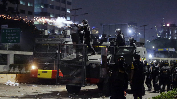 Police fired tear gas and water cannons on Tuesday to disperse thousands of rock-throwing students in Jakarta on Tuesday.