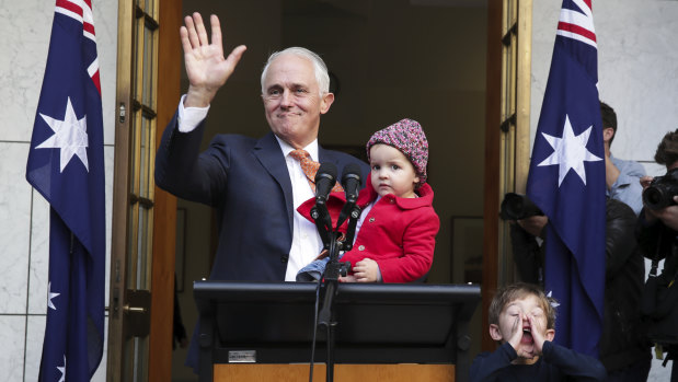 Malcolm Turnbull waves goodbye at the end of his final press conference as prime minister, surrounded by granddaughter Alice and grandson Jack. 