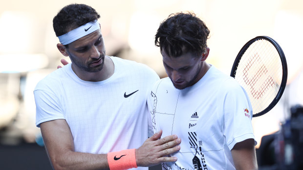 Grigor Dimitrov consoles Dominic Thiem at the net after their fourth-round clash.