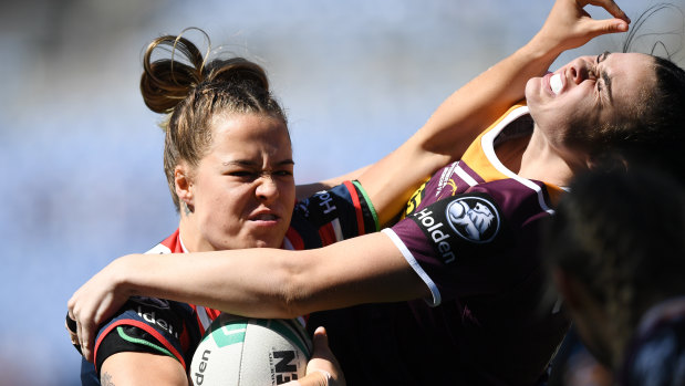 In your face: Isabelle Kelly runs into some Broncos defence.