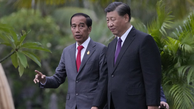 Widodo walks with Chinese President Xi Jinping in Bali, where they met on the sidelines of the G20 summit in November.