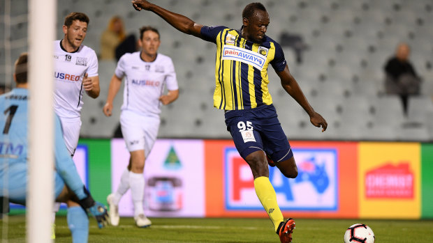 Long shot: Usain Bolt takes a pop at goal against Macarthur South West United at Campbelltown Stadium on Friday.