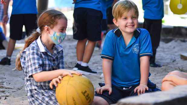 Grade one pupils from Carlton Gardens Primary School Rosie Fraser-Torrance and Oscar Thomas are happy to be back in the classroom.