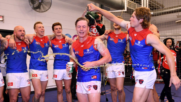 Charlie Spargo (centre) celebrates after the Demons win over Essendon last year.