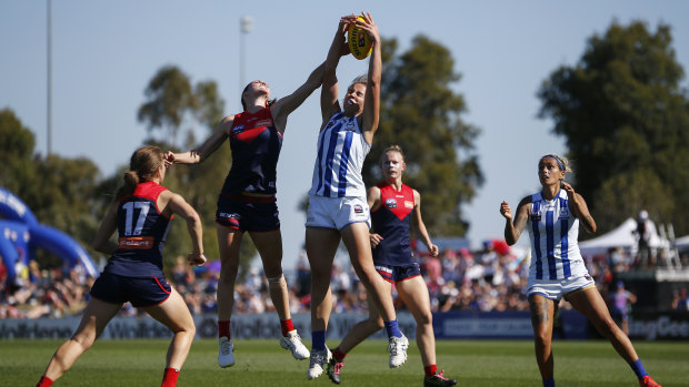 Ruck royalty: North Melbourne's Emma King marks under pressure from Lauren Pearce of the Demons.
