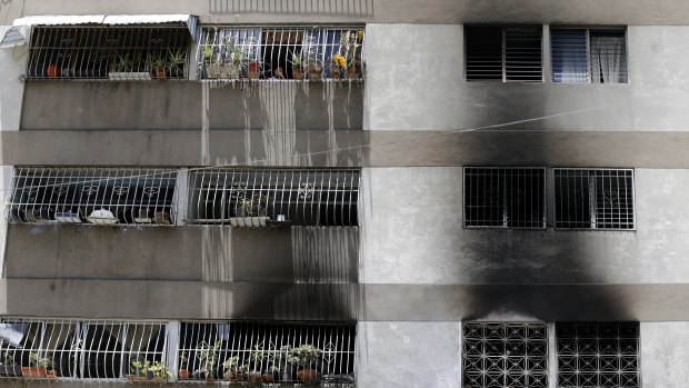 Signs of smoke cover the apartment complex where an allegedly armed drone crashed, causing a fire, in Caracas.