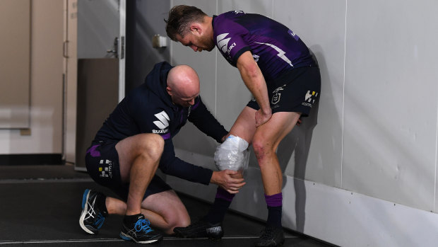 Cameron Munster hobbles out of the Storm's win over Parramatta on Saturday night.