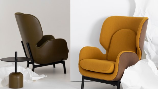 The"Aviso" armchair with a leather and fabric upholstered seat and matching pedestal table.