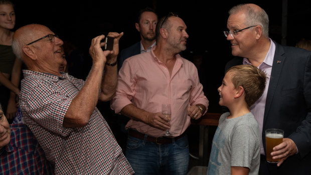 Prime Minister Scott Morrison poses with guests at a Politics in the Pub session in Perth this week.