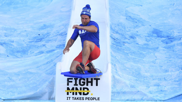 Bulldogs coach Luke Beveridge sets a new standard, surfing down the Big Freeze ramp.