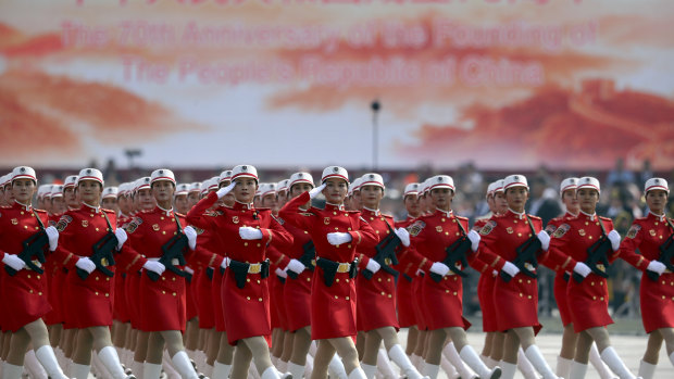 Chinese female militia members march at a parade to commemorate the 70th anniversary of the founding of Communist China in Beijing.