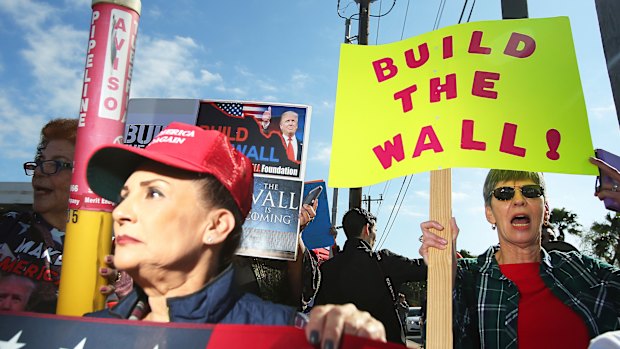 Supporters react during a visit by US President Donald Trump at McAllen Miller International Airport in McAllen, Texas, on Thursday.