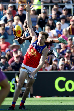 Junior Rioli of the Power flies over the Lions’ Harris Andrews at Adelaide Oval.