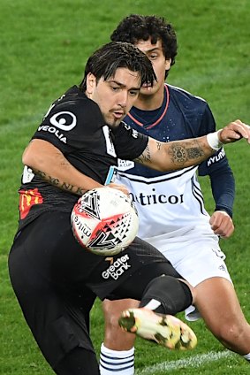 Deft flick: Dimitri Petratos of the Jets (left) plays the ball on under pressure from Victory's Brandon Lauton.