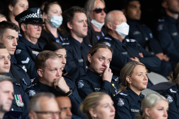 Mourners listening to tributes from family.