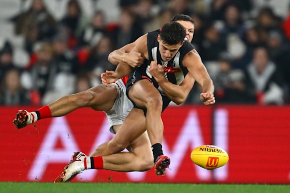 Marcus Windhager lays a crunching tackle on Nick Daicos.