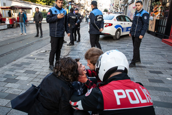 Police care for a boy who was separated from his parents during an explosion in Istanbul. 