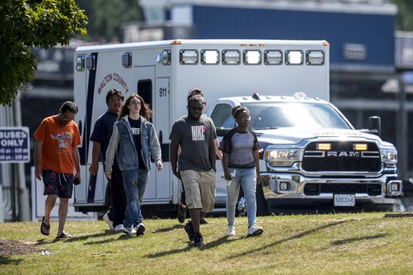 Students and parents walk off campus at Apalachee High School.