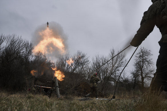 Ukrainian soldiers fire a mortar towards Russian positions, near Bakhmut,