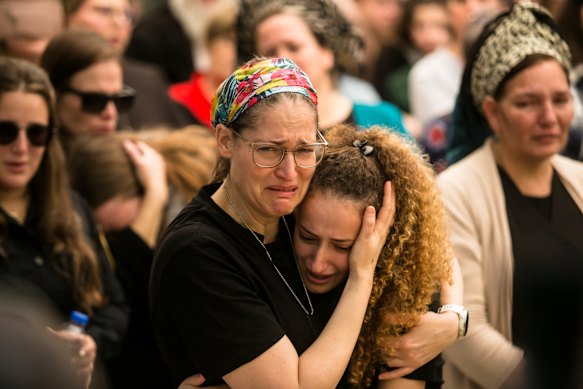 Tami Cohen and her daughter Hadas at a funeral for their husband and father,  Major (res.) Eviatar Cohen who was killed fighting in southern Gaza.