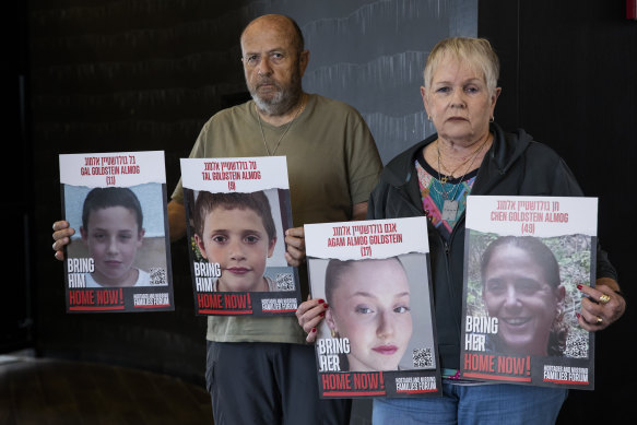 David and Varda Goldstein with photos of their grandchildren, Gal, Tal and Agam, and their mother, Chen, who were kidnapped on October 7.