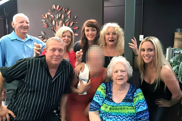 Evelyn (centre) surrounded by some of her children and grandchildren in 2018  (left to right): John Weller, Adam Dixon, Kimberly Dixon, Ally Dixon (rear), a family member who does not want to be identified, Michelle Dixon, and Alana Dixon. 