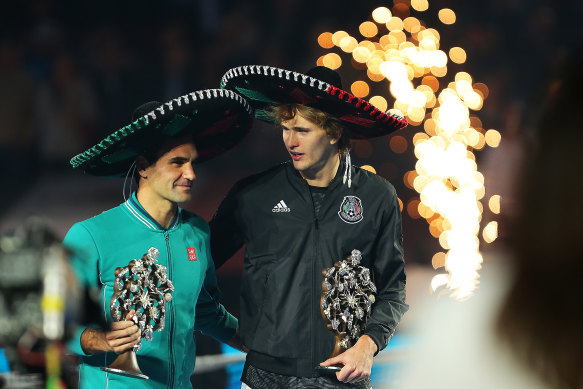 Roger Federer and Aexander Zverev chat during the post-match festivities in Mexico.