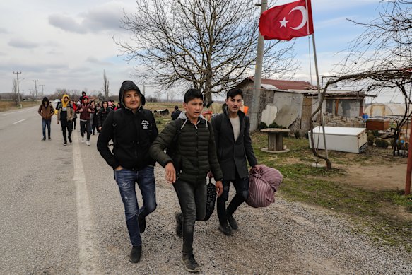 Refugees coming from Turkey try to cross the border into Greece on Friday.