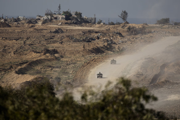 Israeli troops leave the Gaza Strip as seen from a position at the Israeli side of the border on January 8.
