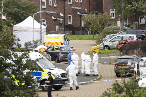 Police teams work near the shooting scene on Biddick Drive in Plymouth.