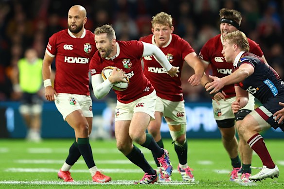 Elliot Daly of the British & Irish Lions makes a break against the Reds