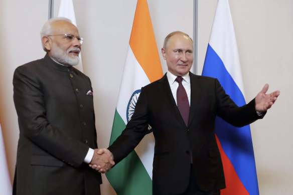 Indian President Narendra Modi (left) has held back from publicly censuring Putin because India needs Russian weapons in its standoff with China, according to Bloomberg.  