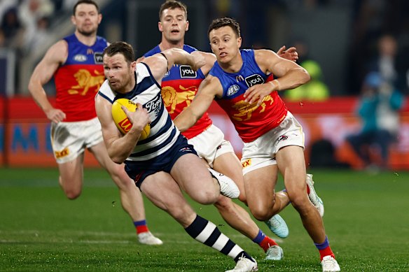 Lions star Hugh McCluggage gives chase to Geelong captain Patrick Dangerfield.