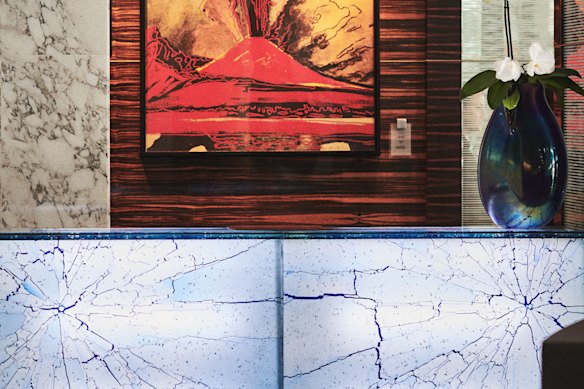 An Andy Warhol print from his 1985 Vesuvius series is hung behind reception.
